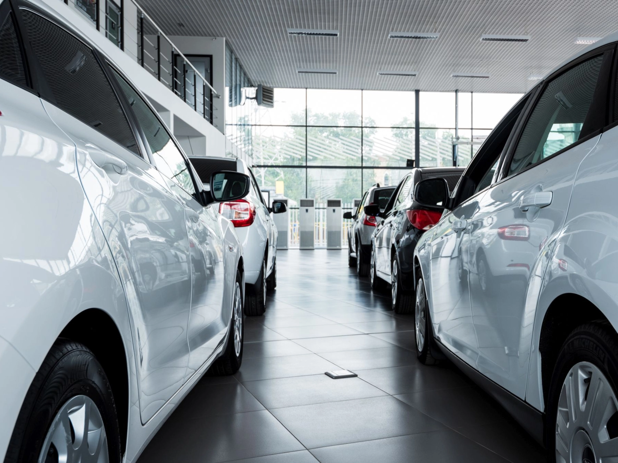Autos stehen in einem Autohaus zum Verkauf bereit